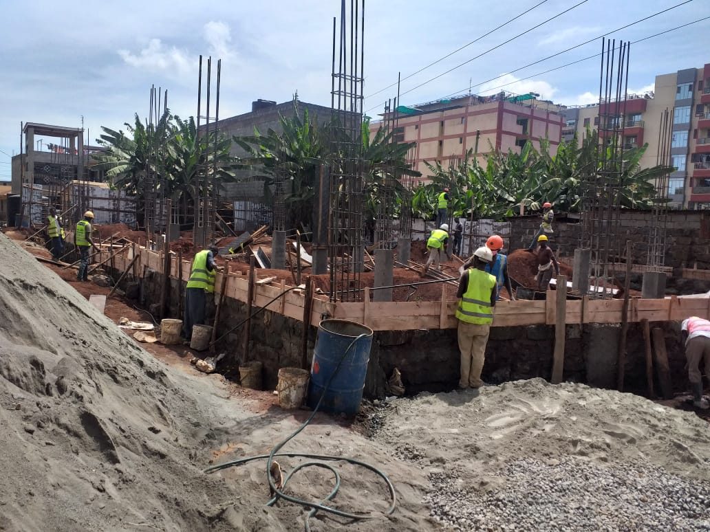 Sand and ballast stockpiled beside foundation formwork