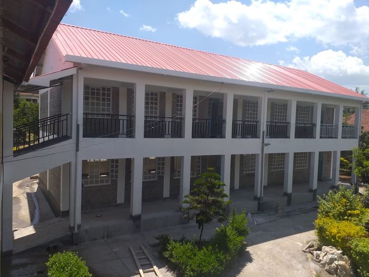 Upper veranda of a classroom block under a red roof