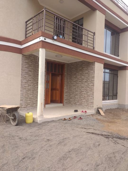 Residence entrance with a timber door and stone cladding